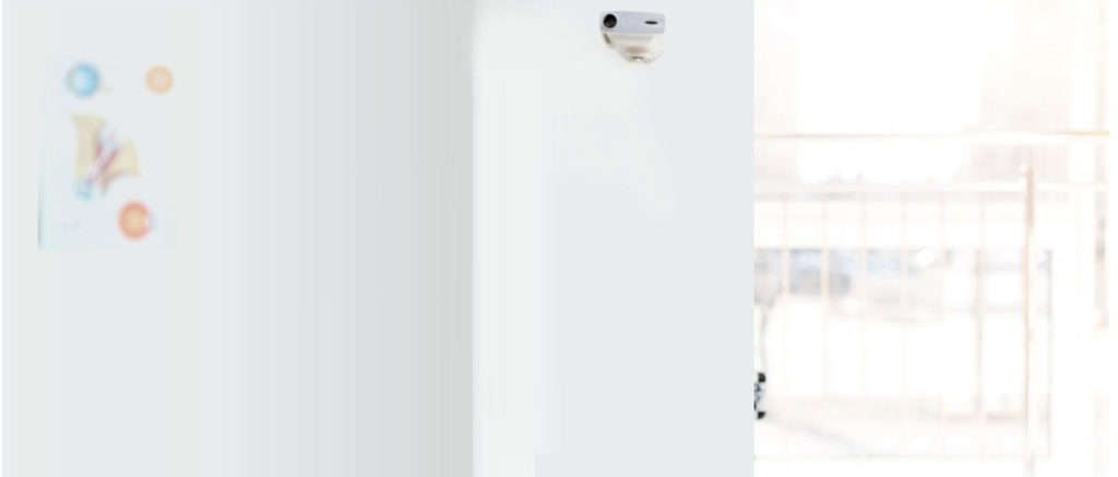A white refrigerator freezer sitting in the middle of a room.